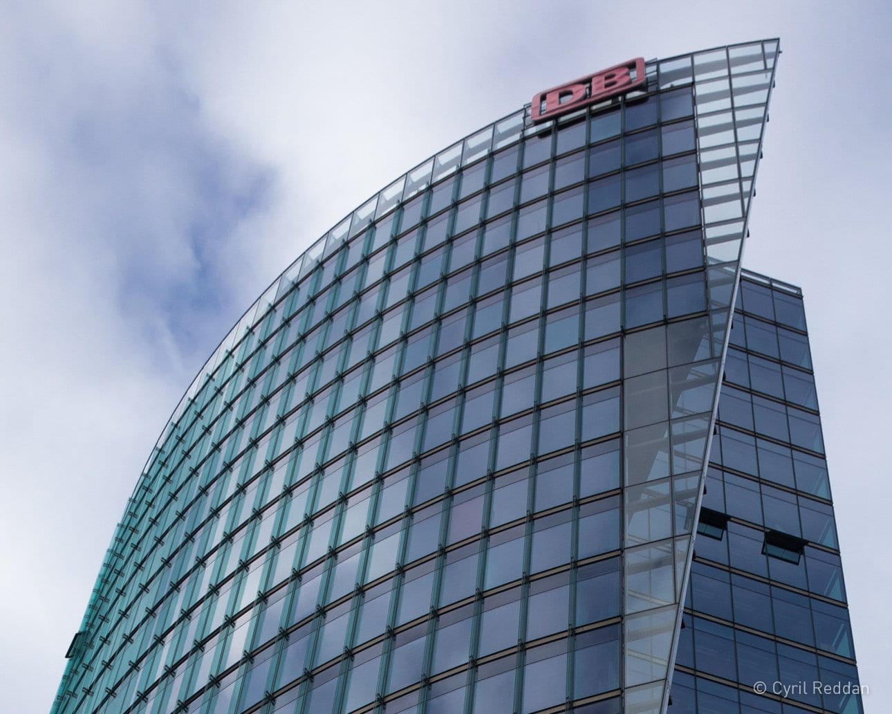 Looking up at a beautifully designed architectural glass exterior by Helmut Jahn
