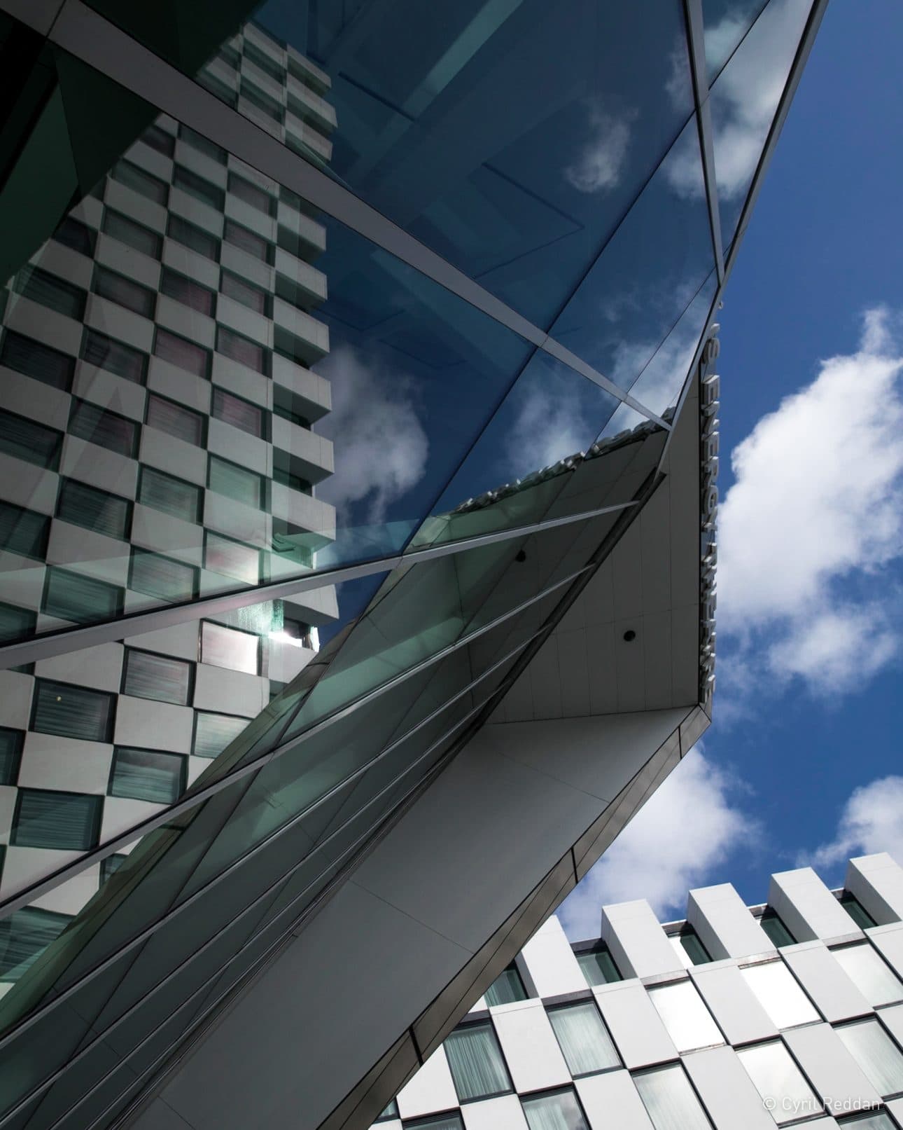 The Maker Hotel glass exterior reflecting the sky