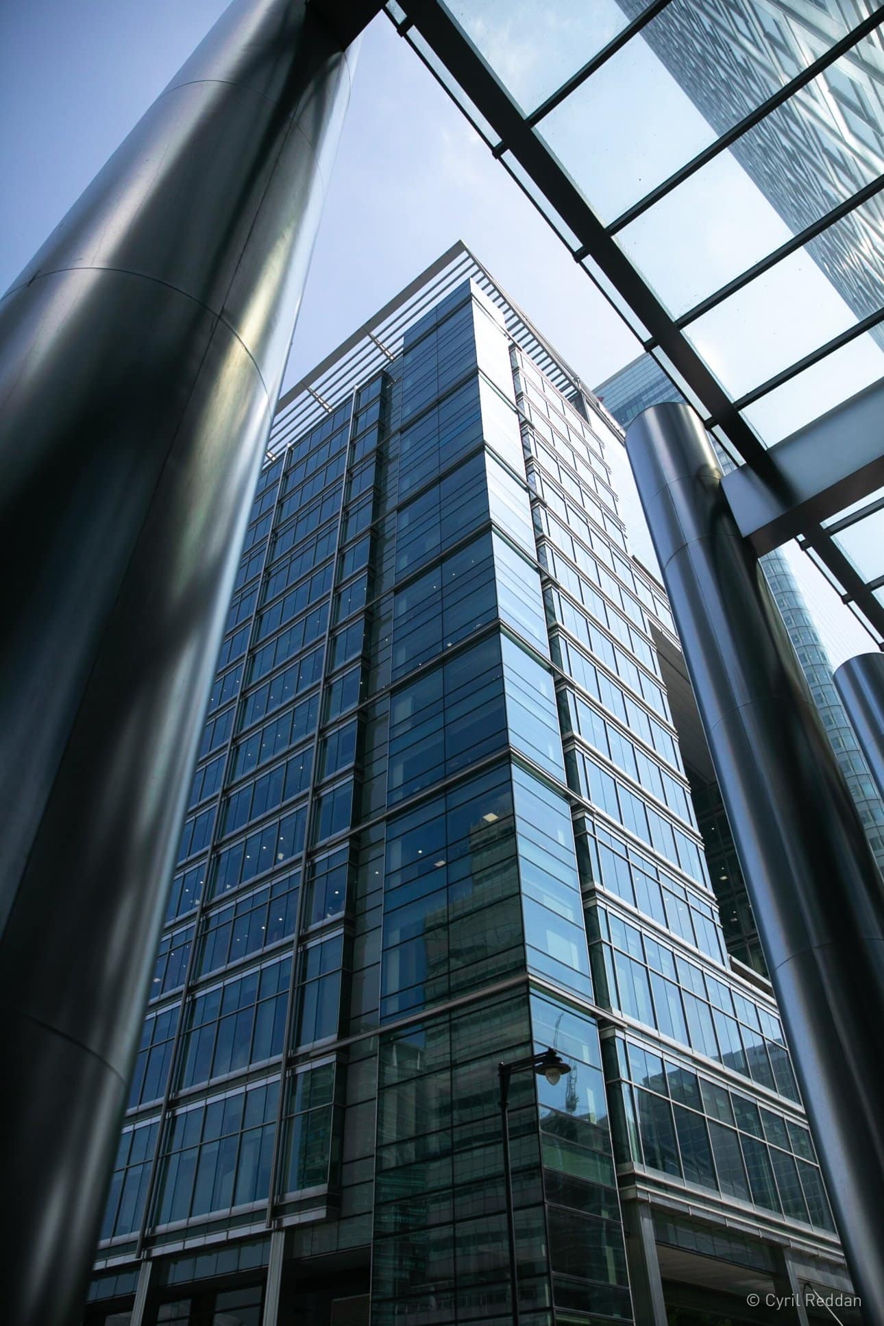 Looking up at a beautiful modern glass facade of a london building by Troughton Mc Aslan