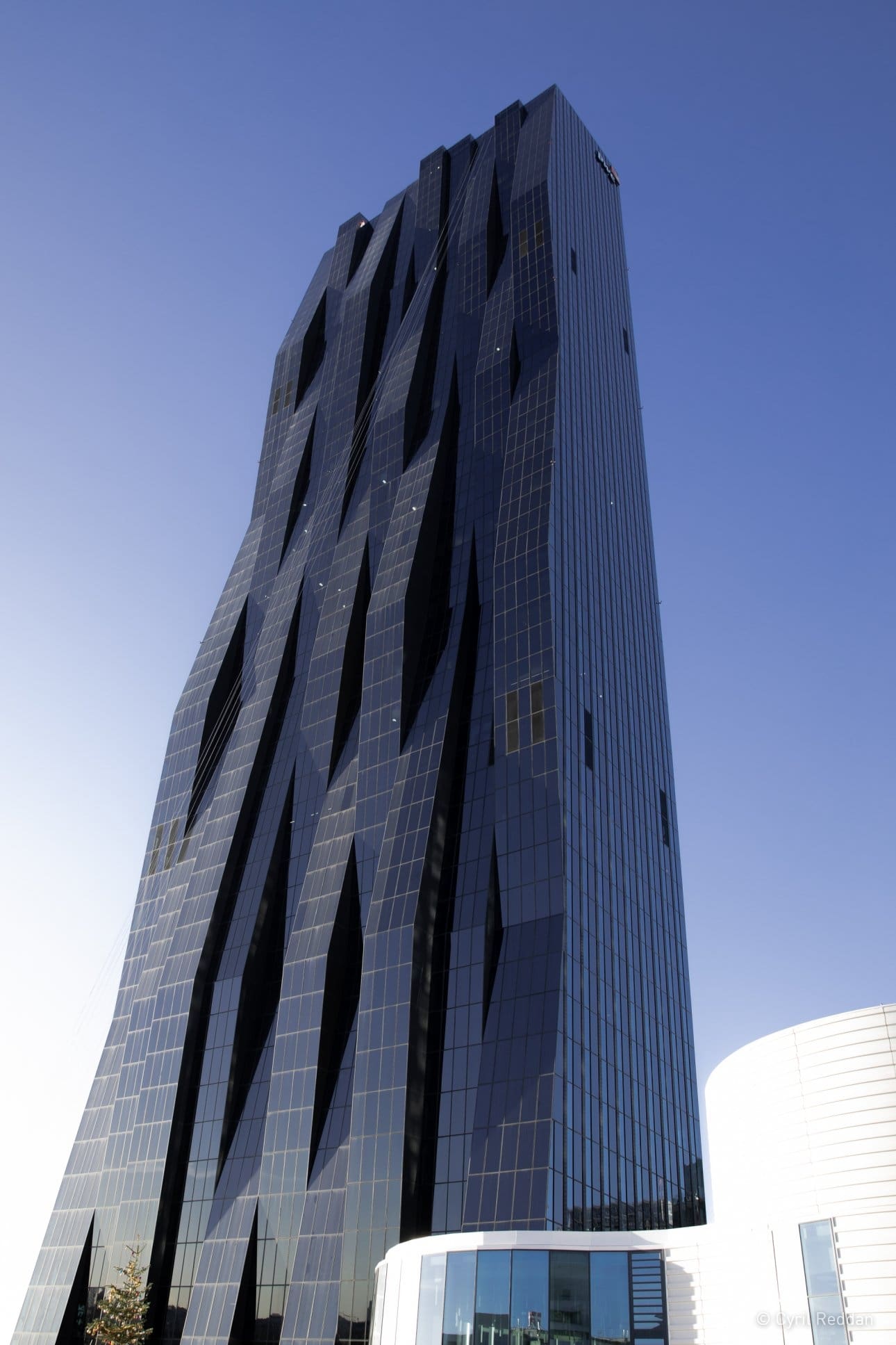 Intricate glass facade of tall building against the sky